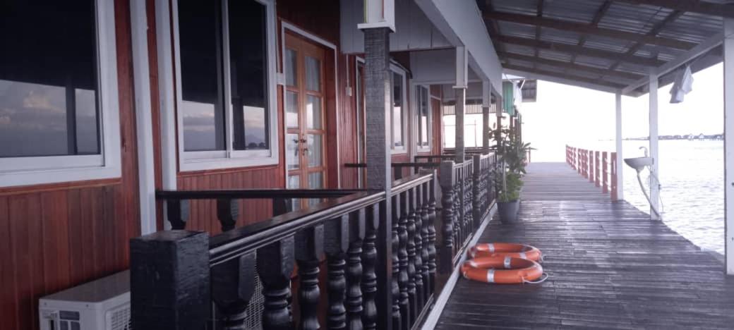 Wooden overwater walkway and shared balcony exterior at Sea Plus Water Chalet Resort. An intimate over the water escape in Semporna offering fresh ocean breeze and sea views.